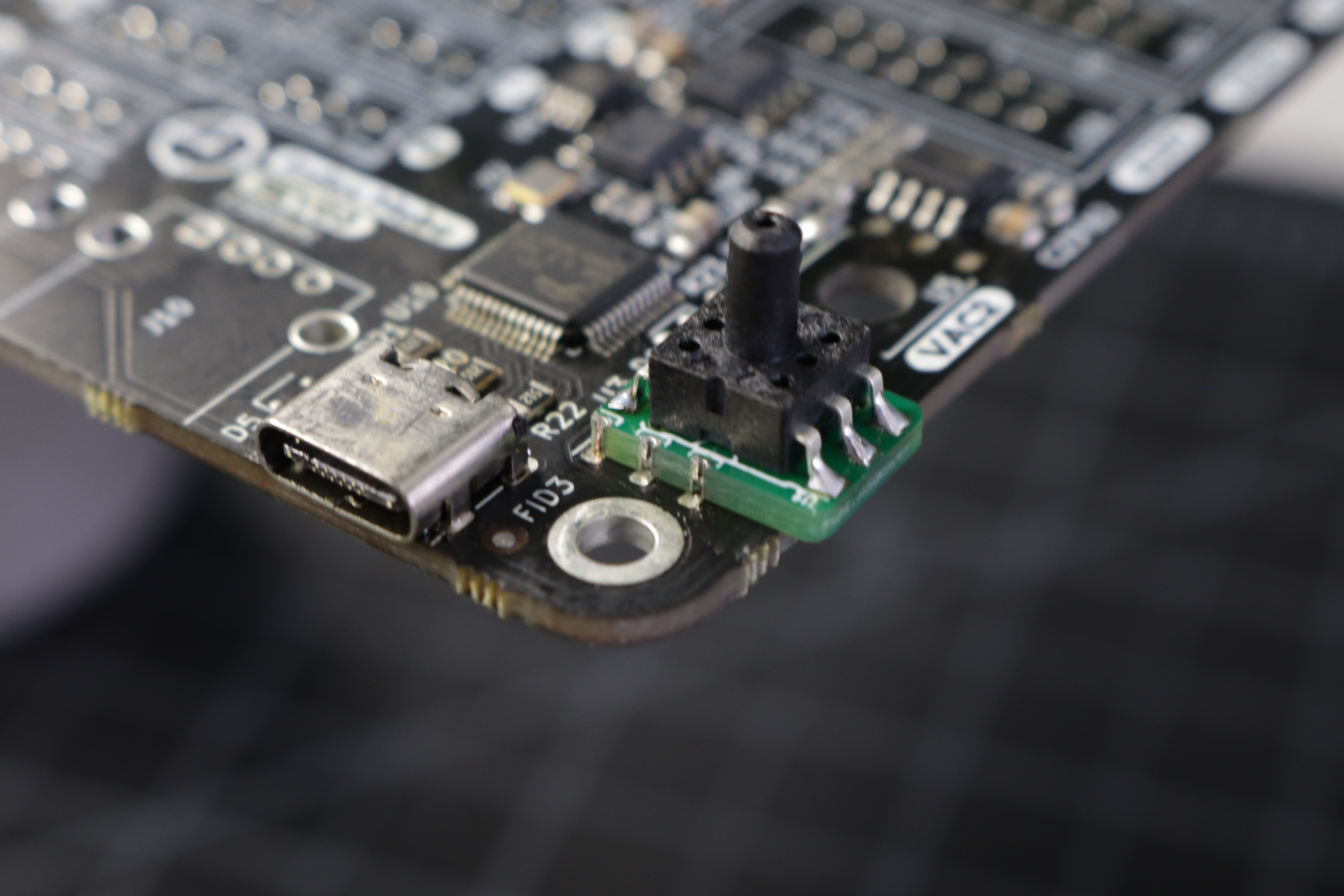 A photo of the interposer placed on the motherboard, with the lower edge overhanging slightly